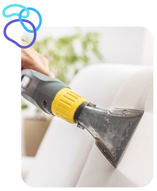 Professional upholstery cleaning in Duval County – technician deep cleaning a sectional couch with steam equipment